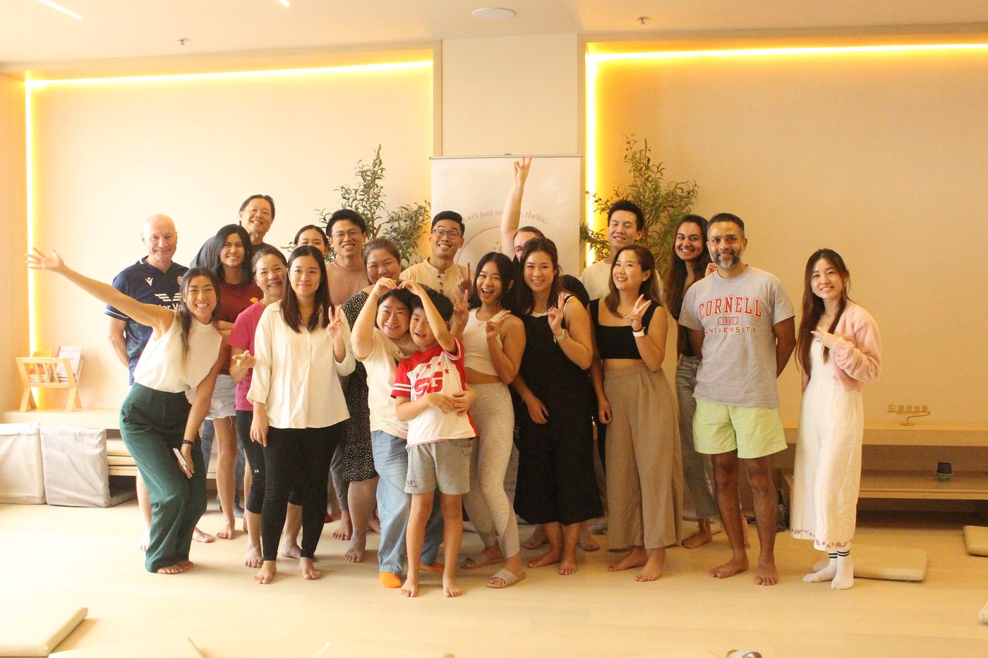 A large, smiling group of Tryve community members pose together