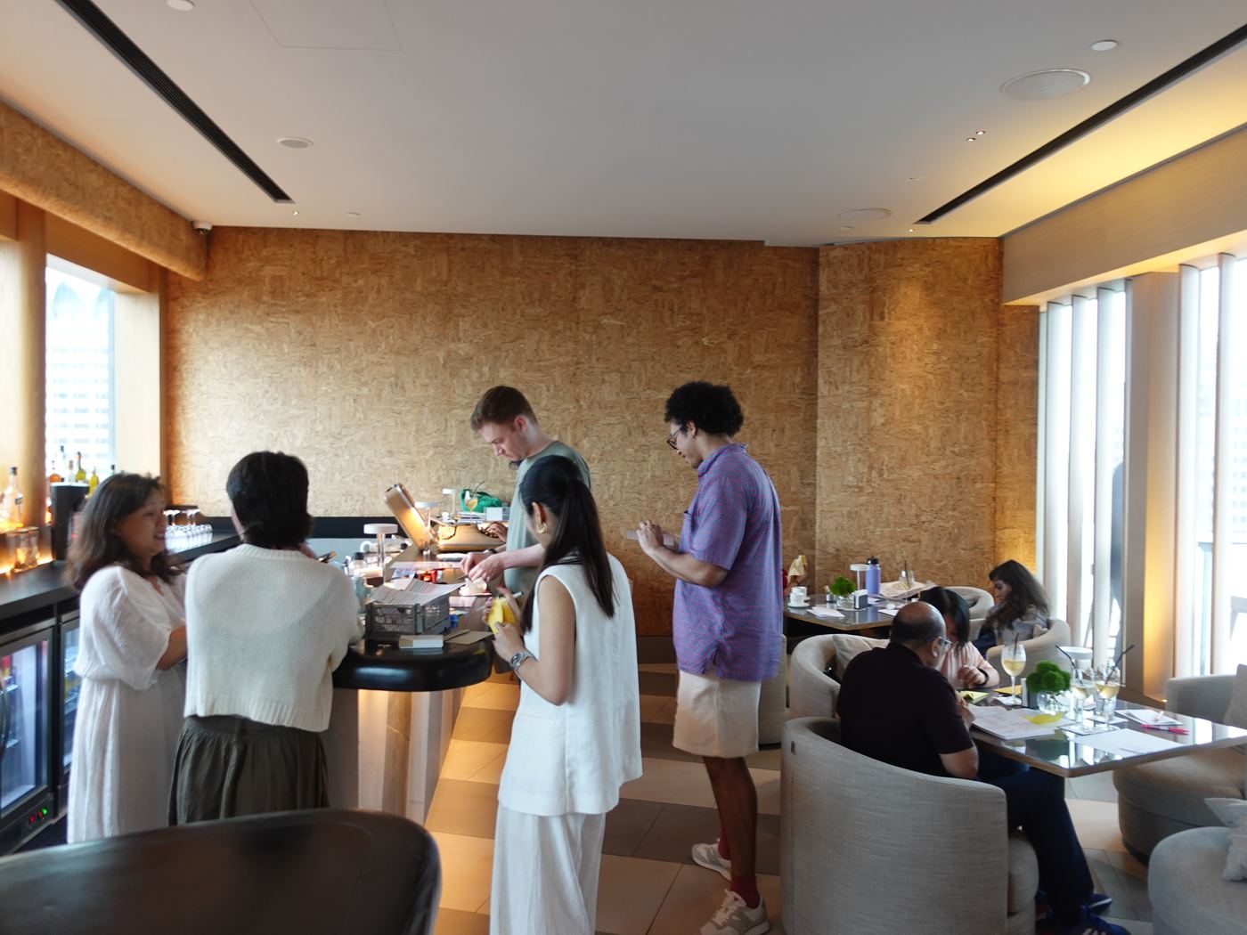 Guests mingle around the bar in a bright room