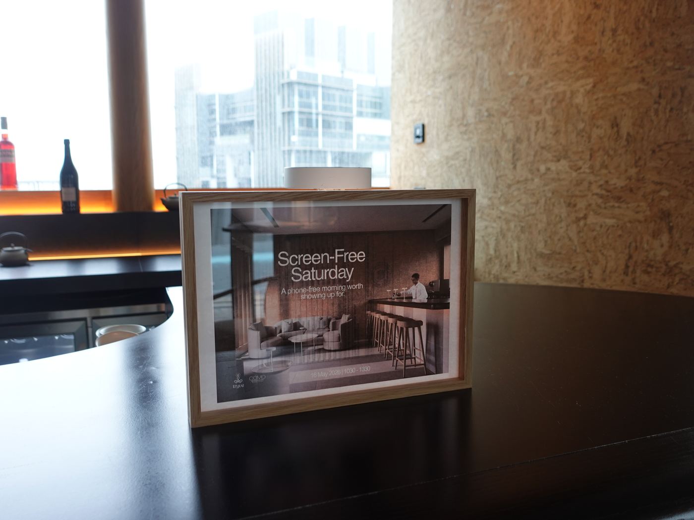A framed Screen-Free Saturday sign on the bar