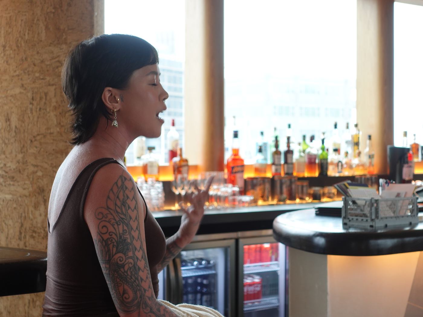 A speaker addresses the room from beside the bar