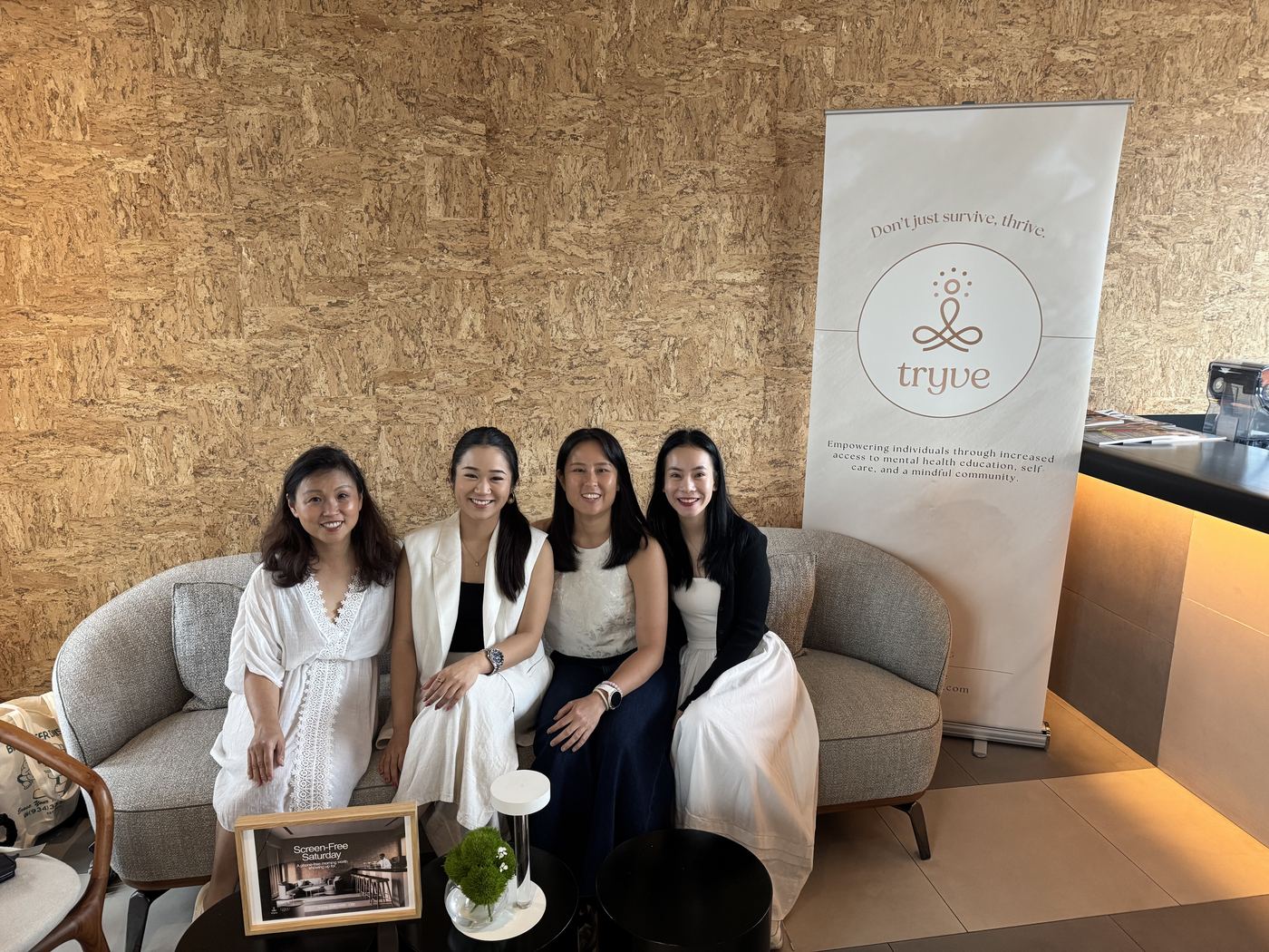 The Tryve team together on a sofa beside the Tryve banner at COMO, May 2026