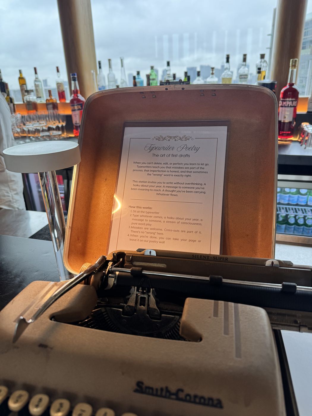 A vintage typewriter with a typed prompt sheet