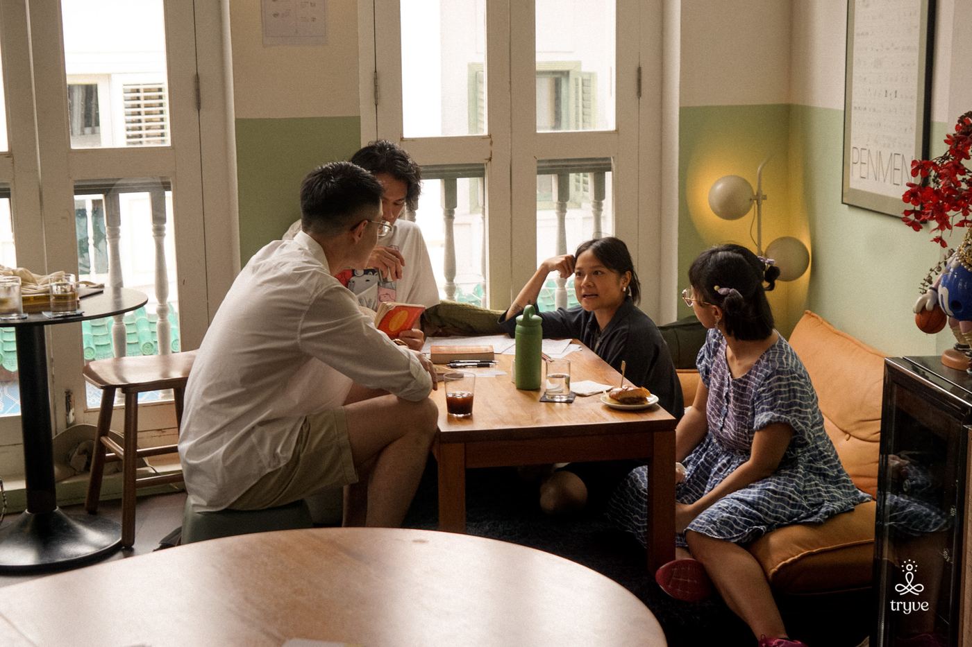 A small group chats around a corner table