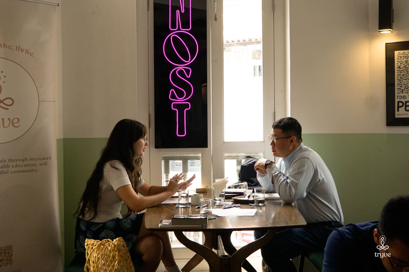 Two guests in conversation across a table