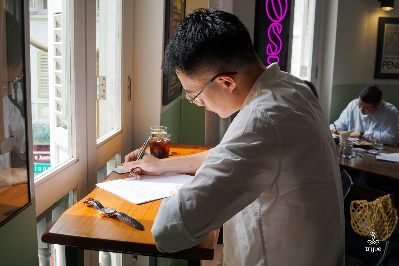 A guest writes by the window